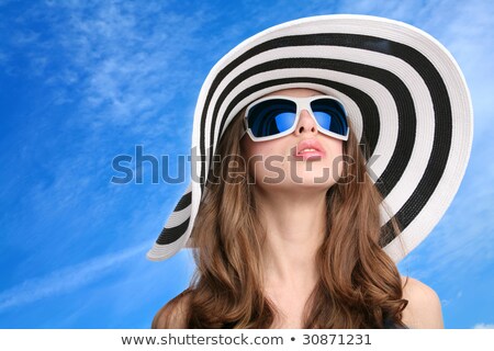 Foto d'archivio: Beautiful Girl In Sunglasses On Background Blue Sky