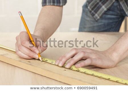 ストックフォト: A Carpenter Taking Measures Onsite