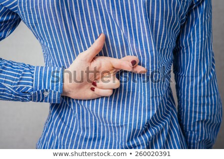 Stock photo: Liar Businesswoman With Crossed Fingers At Back