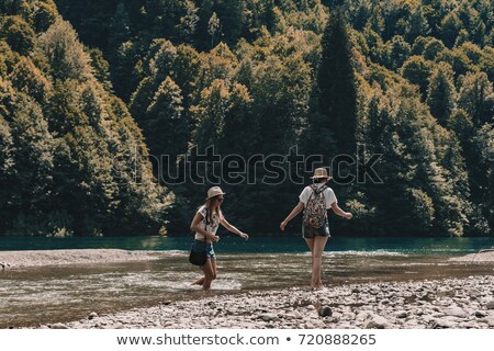 Stock fotó: Two Girls Crossing The Stream In Nature