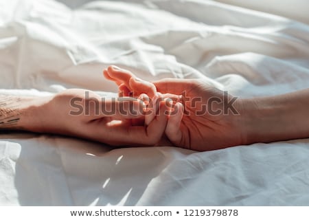 Stock photo: Couple Holding Hands In Bed