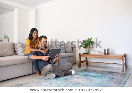 Foto d'archivio: Couple At Home Woman Using Laptop