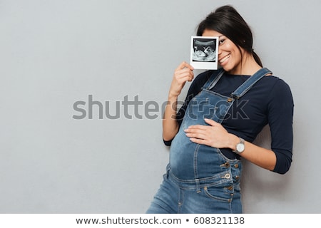 Foto d'archivio: Pregnant Womans Belly And Ultrasound Over White Background