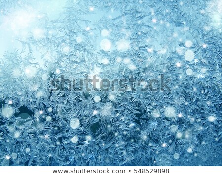 Foto stock: Ice Pattern And Sunlight On Winter Glass