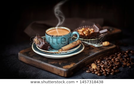 ストックフォト: Cup Of Coffee With Cinnamon Sticks On Wooden Table