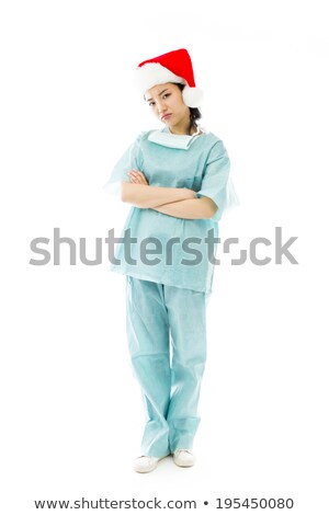 Stockfoto: Upset Asian Female Surgeon Wearing Santa Hat