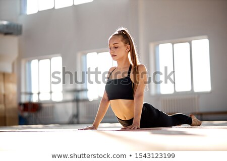 Stockfoto: Acrobat Woman Stretching On The Floor