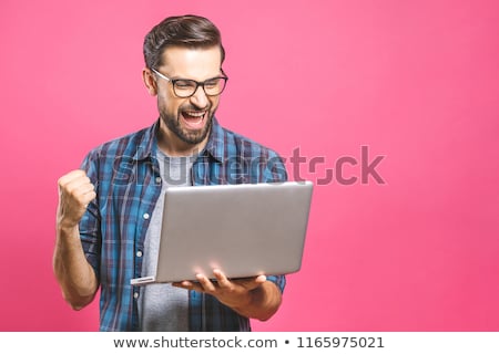 Stok fotoğraf: Portrait Of Handsome Young Man Holding Laptop Computer And Worki