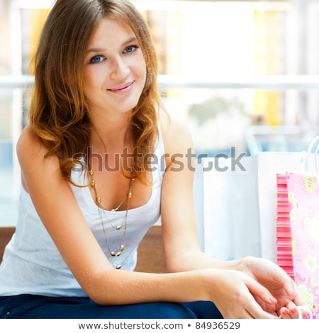 Stockfoto: Happy Shopping Woman At The Mall Preparing Gifts For Her Friends