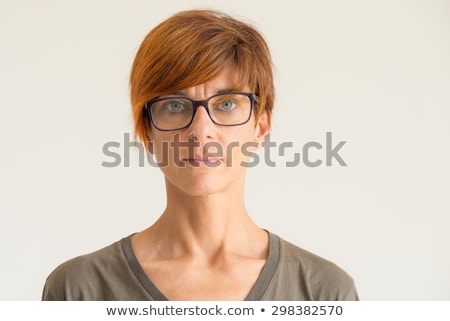 Foto d'archivio: Portrait Of A Sad Woman Looking At The Camera Against A White Background