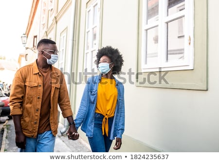 Stock fotó: Two Smiling Men Walking Down A Street