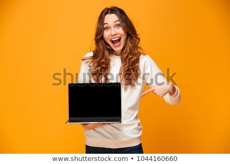 Zdjęcia stock: Woman Pointing Finger On Blank Laptop Computer Screen