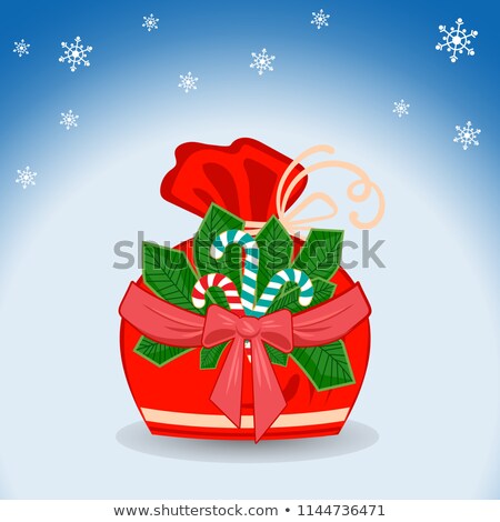 Foto stock: Winter Sack With Stripe Branch With Red Bow And Ribbon Sweet Candy And Snowflakes On Blue Backgroun