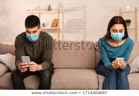 [[stock_photo]]: Men And Woman Sitting On Sofa
