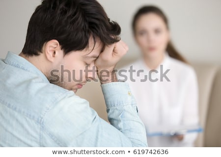 Foto stock: Man Patient Having A Migraine Headache And Female Doctor In The