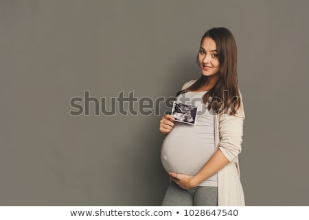 Foto d'archivio: Expectant Woman Hold Sonogram Image