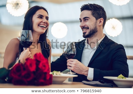 Stock fotó: Elegant Young Woman In A Red Dress Having A Glass Of Red Wine