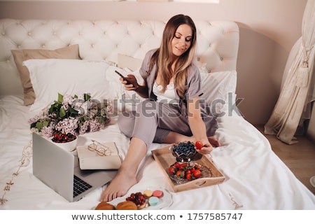 Foto stock: Young Beautiful Girl Sitting On A Bed