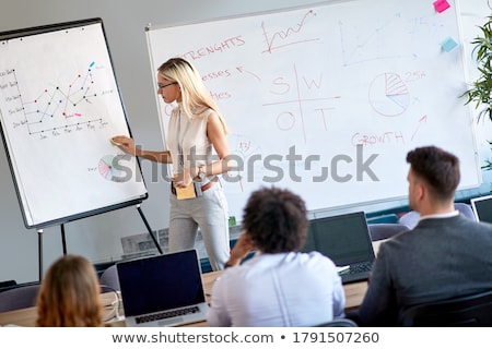 Foto stock: Blonde Businesswoman Showing Financial Diagram