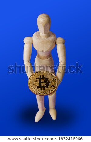 Stok fotoğraf: Wooden Figurine Holding A Gold Coin