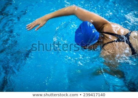 Foto stock: Female Swimmer In An Indoor Swimming Pool - Doing Crawl