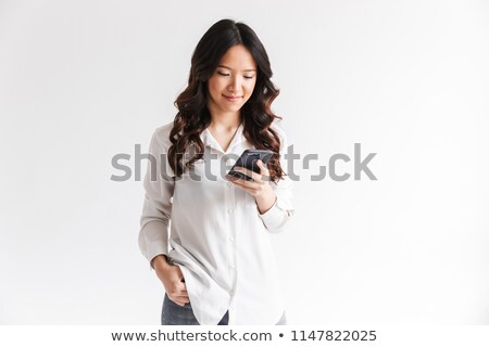 ストックフォト: Photo Of Young Asian Woman With Long Dark Hair Holding And Using