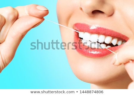 Stock fotó: Woman Cleaning Teeth With Dental Floss