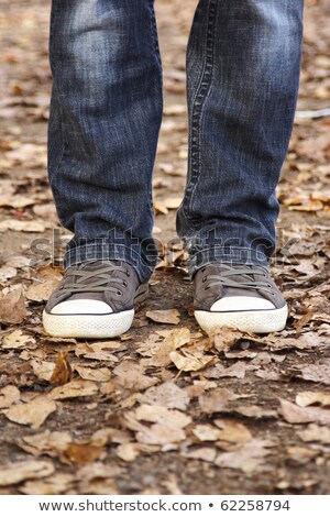 Stockfoto: Blue Female Or Male Sneakers And Jeans