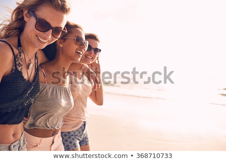 Foto stock: Group Of Smiling Women In Sunglasses On Beach