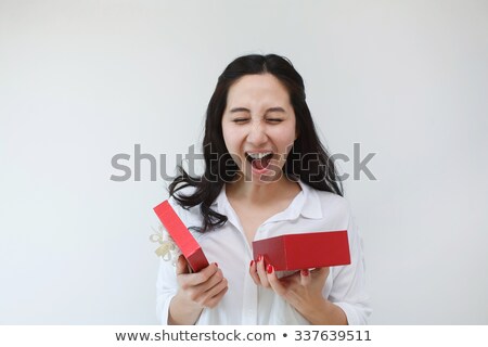 Foto d'archivio: Asian Woman Holding A Gift Package Wrapped With Ribbon