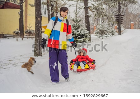 Stock photo: Dad And Son Have Fun On Tubing In The Winter Winter Fun For The Whole Family