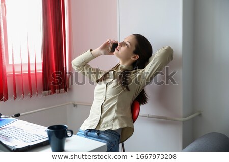 [[stock_photo]]: Woman On Her Cell Phone And Laptop In The City Lights