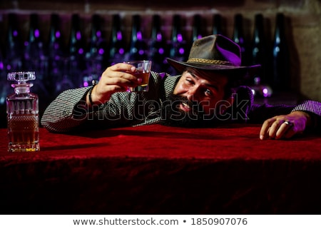 Foto stock: Young Cowboy With A Bottle