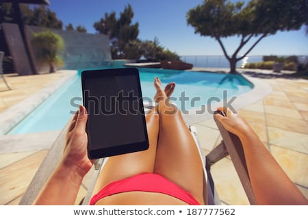 Stockfoto: Woman In Bikini With Tablet Pc Computer