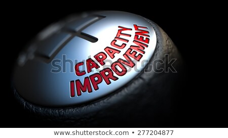 Stockfoto: Capacity Improvement On Gear Shift With Red Text