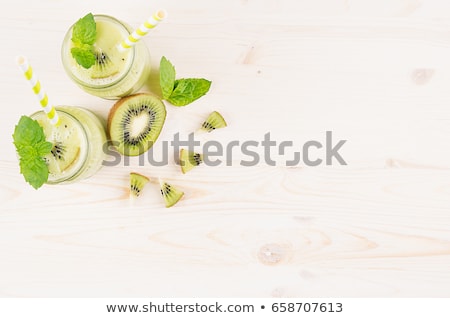 Stock fotó: Freshly Blended Green Kiwi Fruit Smoothie In Glass Jars With Straw Mint Leaf Cute Ripe Berry Top