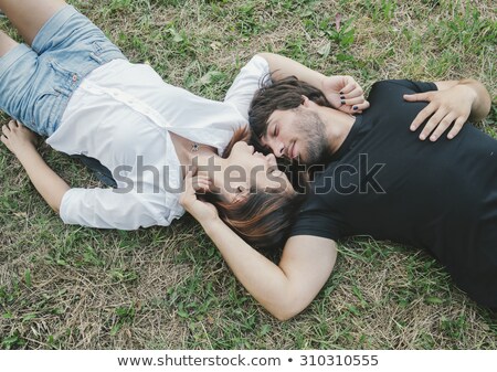 Stok fotoğraf: Young Couple Kissing In Countryside - Two Teens Lovers At The Be