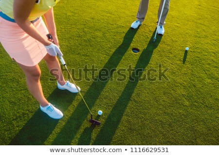 Woman Player Ready To Hit The Ball Into The Hole At The End Of A Game Foto stock © Kzenon