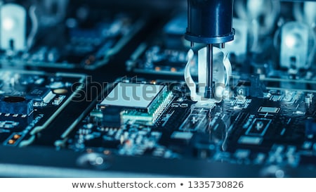 [[stock_photo]]: Robot Placing Processor Chip In Motherboard