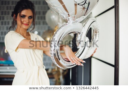 [[stock_photo]]: Brunette Bride Showing Hand With Wedding Ring And Hiding Face