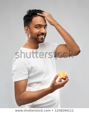 ストックフォト: Indian Man Applying Hair Wax Or Styling Gel