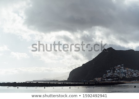 Foto stock: View From The Height Of The Golden Sand Palm Trees Sun Loungers Cloudy Weather