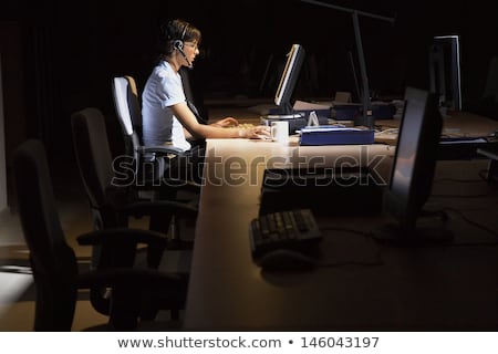 Stock fotó: Hacker With Computer And Headset In Dark Room