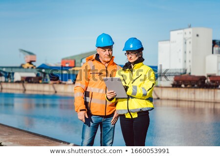 [[stock_photo]]: Workers Waiting For A Delivery At Commercial River Port