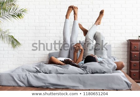 Сток-фото: Young Adult Couple Lying On Bed