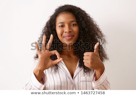 [[stock_photo]]: Smiling Casual Woman Making The Ok Thumbs Up Hand Sign