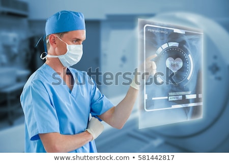 Foto stock: Male Nurse Touching An Invisible Screen