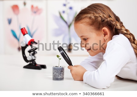 Foto stock: Kids Or Students With Microscope Biology At School