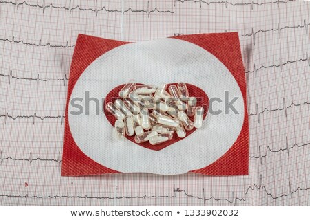 Foto stock: Cardiology Macro Of Ecg Graph And Cardio Pills