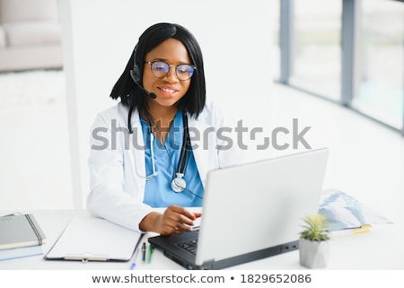 Stok fotoğraf: Doctor With A Cellphone And Laptop Computer